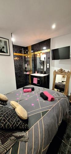 a bedroom with a bed with pink pillows on it at Suite Love Room in Marseille