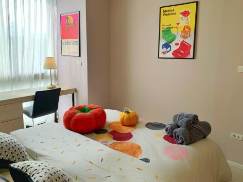 a bedroom with a bed with pumpkins on it at Palm Springs Fountain Nimman Condominium in Chiang Mai