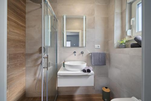 a bathroom with a sink and a shower at Vice's Place - Sea-View & Pool in Slatine