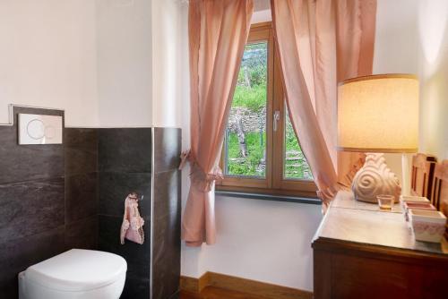 a bathroom with a toilet and a window at Ca' du Re in Chiavari