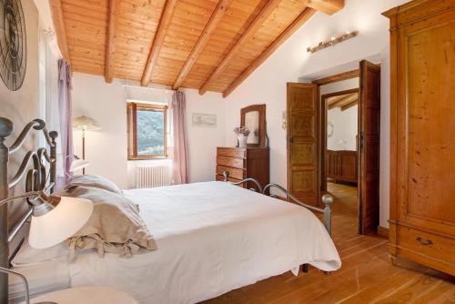 a bedroom with a bed and a wooden ceiling at Ca' du Re in Chiavari