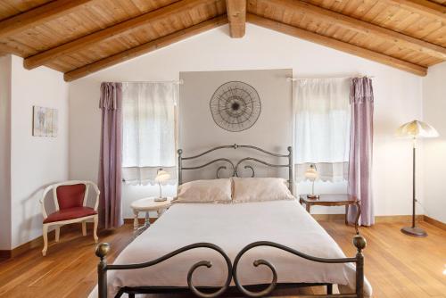 a bedroom with a large bed and two windows at Ca' du Re in Chiavari