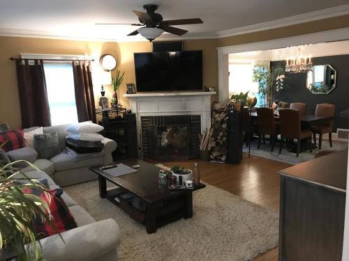 a living room with a couch and a fireplace at Beautiful Luxury Suite A & B of Shorewood Home in Shorewood