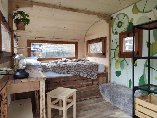a bedroom with a bed in a tiny house at Lu Garun Rus in Valdieri