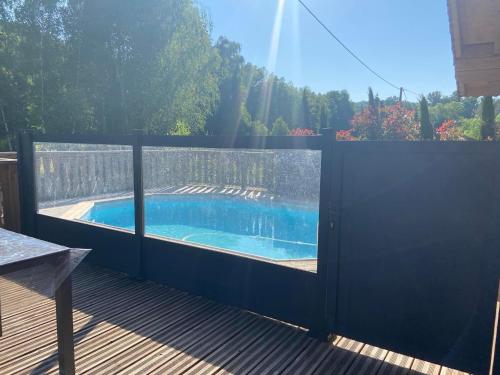 a fence around a swimming pool on a deck at Chalet du Liesthal in Obersteinbach