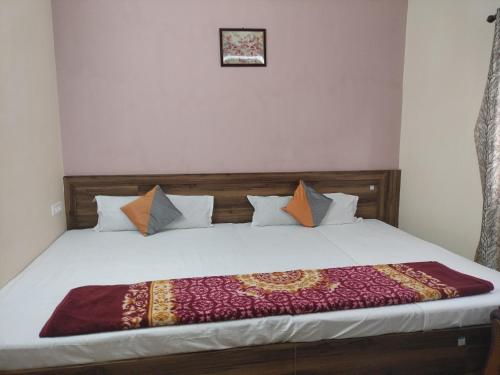 a bed in a room with at Milan Palace Deoghar in Deoghar