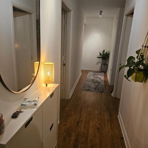 a hallway with a bathroom with a mirror and a sink at Alexandra Park in Manchester