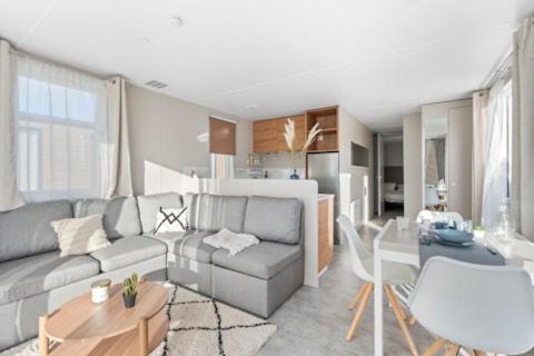 a living room with a couch and a table at Beachside Vakantiepark in Blankenberge