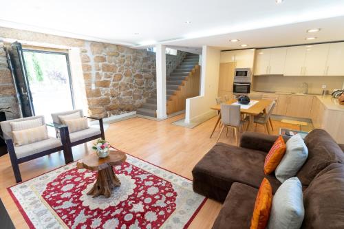 a living room with a couch and a table at Quinta da Terrincha in Torre de Moncorvo