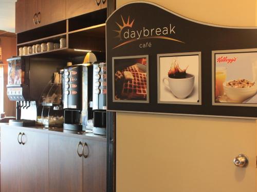 a restaurant with a bar with pictures on the wall at Days Inn by Wyndham Berthierville in Berthierville