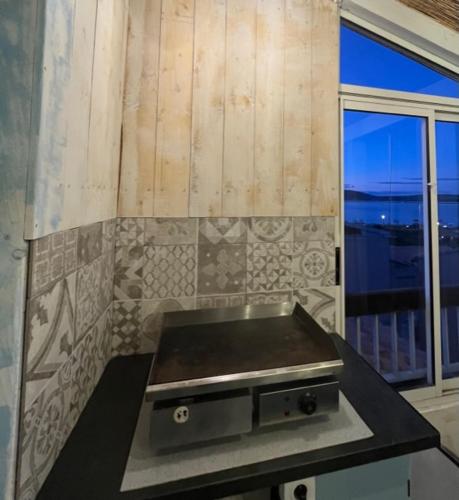 une cuisine avec un comptoir et une fenêtre dans l'établissement Frontignan plage vue mer et étang, à Frontignan