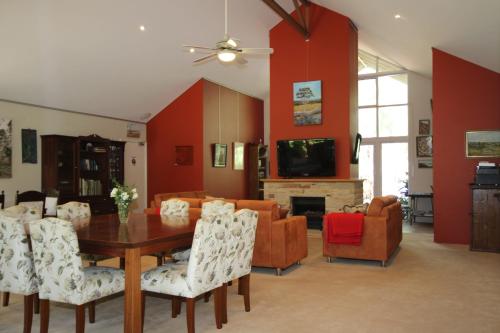 a living room with a wooden table and chairs at Margaret River Bed & Breakfast in Margaret River Town