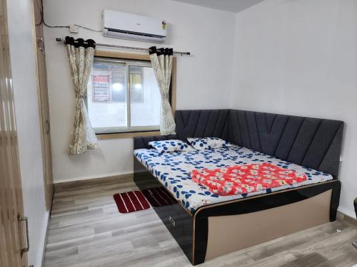 a bed sitting in a room with a couch at 2BHK fully furnished apartment in Indore