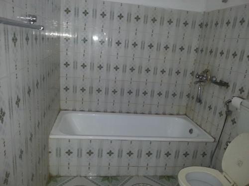 a bathroom with a tub and a toilet at Hotel Shiva's Dream in Sauraha