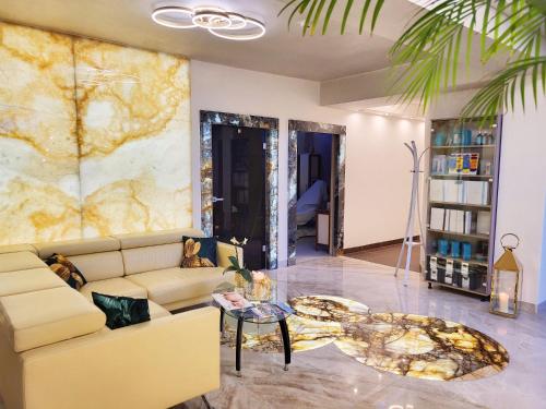 a living room with a couch and a table at Aquapark Health Resort & Medical SPA Panorama Morska All Inclusive in Jarosławiec