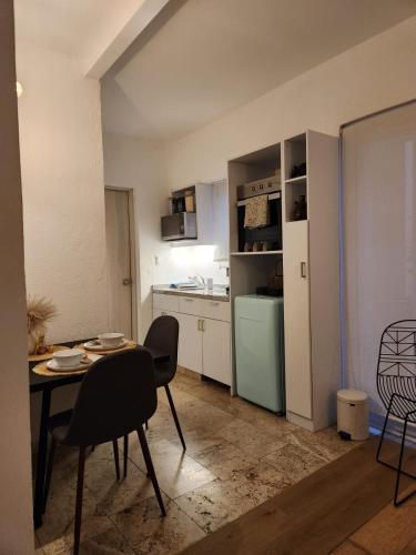 a kitchen with a table and chairs in a room at Downtown Ciudad de México in Mexico City