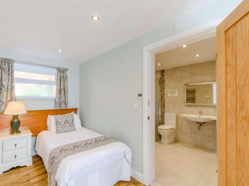 a white bedroom with a bed and a bathroom at 2 Bed in Langtoft 82338 in Weaverthorpe