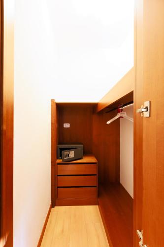 a hallway with a room with a tv in it at Hotel Villa Delle Rose - Malpensa in Oleggio