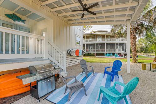 a patio with chairs and a grill on a house at Near State Parks Carrabelle Home with Beach Access! in Big Blackjack Landing