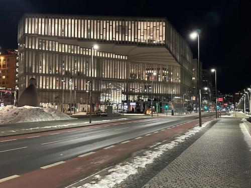 a large building on a city street at night at Cozy apartment by Opera house in Oslo