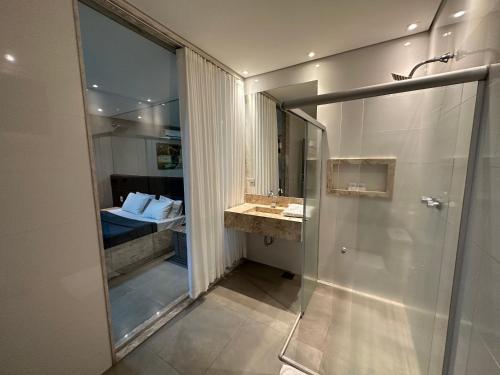 a bathroom with a shower and a sink at Motel Orion - Belo Horizonte in Belo Horizonte