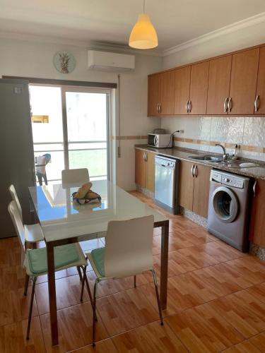a kitchen with a table and chairs and a dining room at Paradise Found - Stunning 3 Bedroom Apartment in Vila Real de Santo António in Vila Real de Santo António