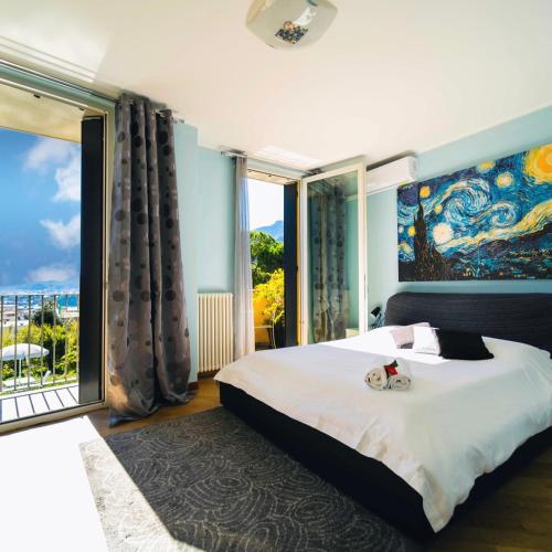a bedroom with a large bed and a large window at Montebello Lake in Lecco