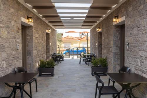 a corridor of a restaurant with tables and chairs at Akti Vigla Apartments in Mytilini