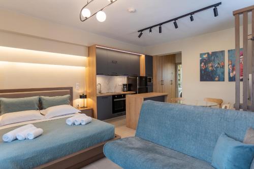 a bedroom with a bed and a blue couch at Akti Vigla Apartments in Mytilini