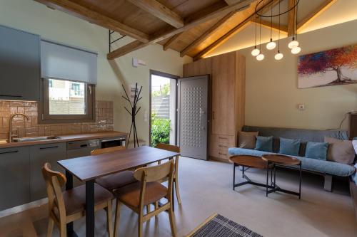 a kitchen and living room with a table and chairs at Akti Vigla Apartments in Mytilini