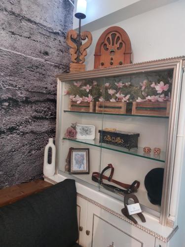 a room with a shelf with flowers on it at George's point of view in Naousa