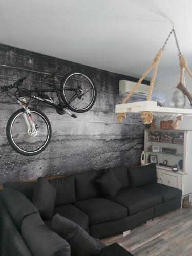 a living room with a bike hanging from a wall at George's point of view in Naousa