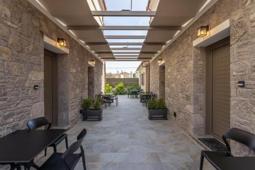 a corridor of a restaurant with tables and chairs at Akti Vigla Apartments in Mytilini