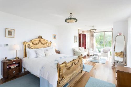 a bedroom with a king sized bed and a living room at Captivating 7-Bed House in Bristol in Bristol