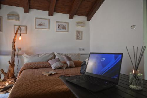 a laptop computer sitting on top of a bed at Agriturismo Il Tintore in Tramonti