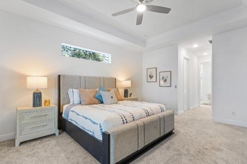 a bedroom with a bed and a ceiling fan at BIG WATER VIEW!, Heated Saltwater Pool and Spa - Villa Manatees Crossing - Roelens in Matlacha