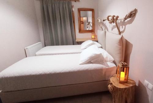 a hotel room with two beds and a mirror at Seven Islands in Gaios