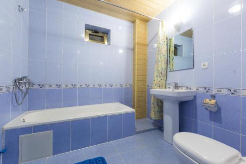 a blue bathroom with a toilet and a sink at Porso Boutique Hotel in Bukhara