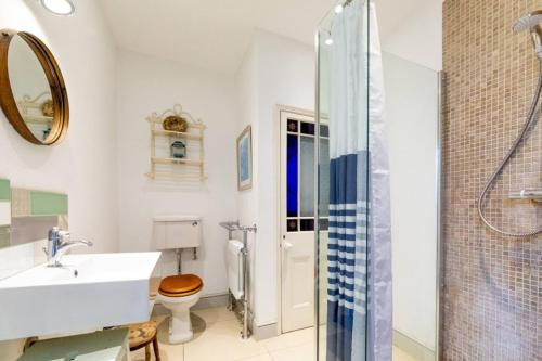 a bathroom with a sink toilet and a shower at York House in Whitstable