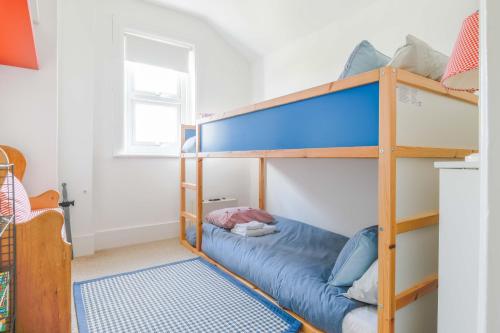 a bedroom with two bunk beds with a blue mattress at Furlong Place in Whitstable