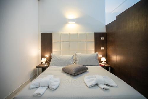 a bedroom with a bed with two towels on it at Morin 10 Rome Exclusive Suites in Rome