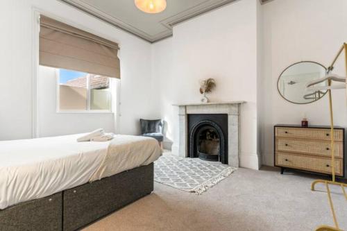 a bedroom with a bed and a fireplace at Station Retreat - Central Location - Free Parking, FastWifi, SmartTV with Netflix by Yoko Property in Redcar
