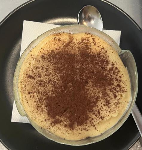 a pot of coffee on a plate with a spoon at HOTEL. RISTORANTE. DELLA POSTA CAMA in Cama