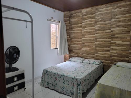 a bedroom with two beds and a walk in shower at Apartamento com ar e exclusivo, zona sul de Ilhéus, bairro Hernani Sá in Ilhéus