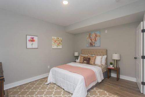 a bedroom with a bed and two pictures on the wall at PRISTINE 3 bdrm - Garage Parking - Close to UPENN in Philadelphia