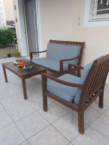 a rocking chair and a coffee table on a porch at House by the sea/Σπίτι στην θάλασσα in Flámbouras