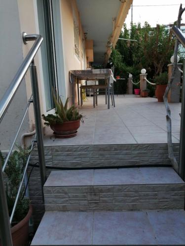 a set of stairs leading to a patio with a table at House by the sea/Σπίτι στην θάλασσα in Flámbouras