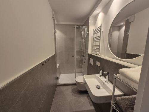 a bathroom with a sink and a toilet and a mirror at Aus alt wird neu - Apartment in Essener City in Essen