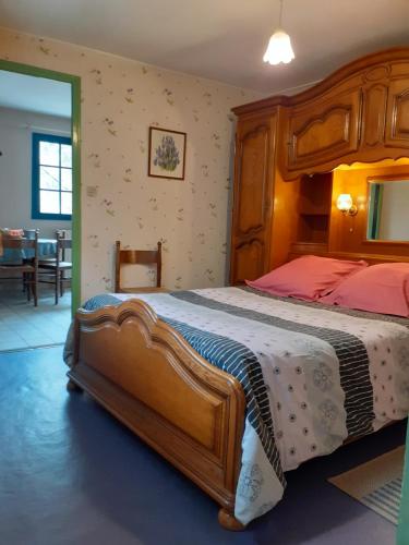 Ponches-EstruvalLes Kiwis的一间卧室配有一张木架大床
