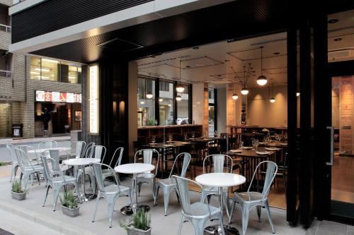 a group of tables and chairs in a restaurant at Hotel Sunroute Ginza in Tokyo